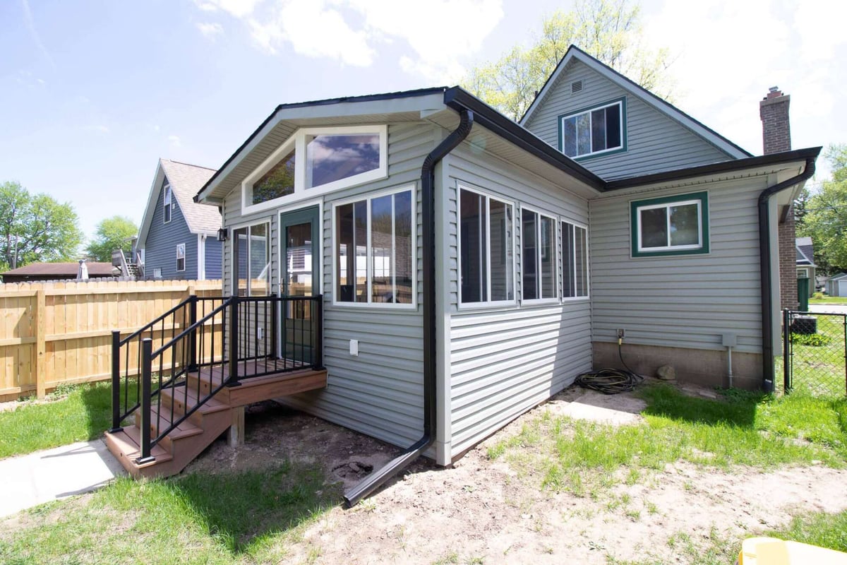 backyard view of new three seasons room addition in Holt, MI by Odd Fellows Contracting
