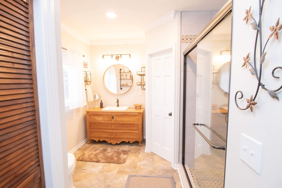 bathroom remodel showing vanity area and new walk in shower with glass enclosure by Odd Fellows Contracting in Webberville, MI