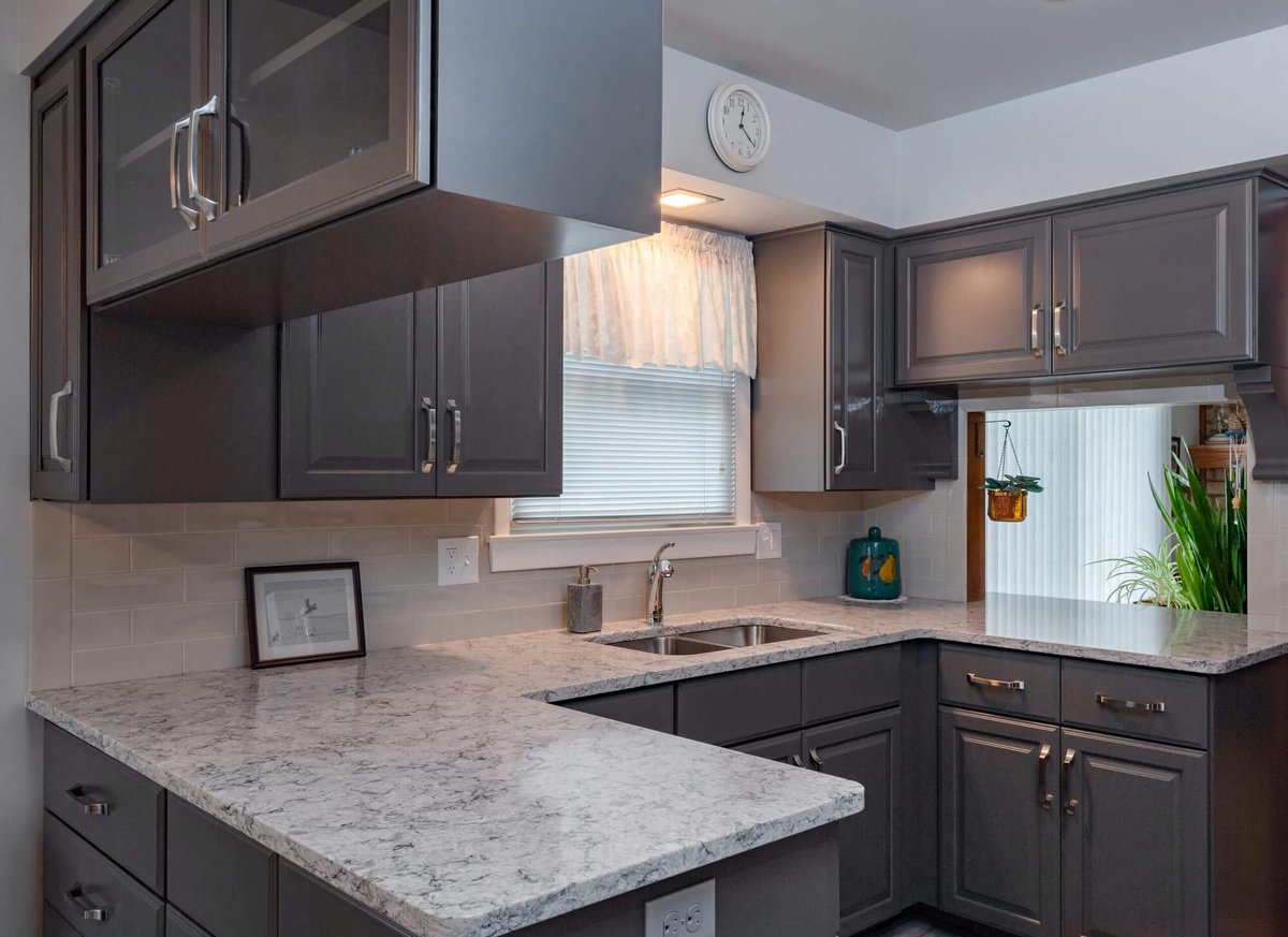 modern kitchen remodel with gray cabinets and quartz peninsula by Odd Fellows Contracting in Lansing, MI