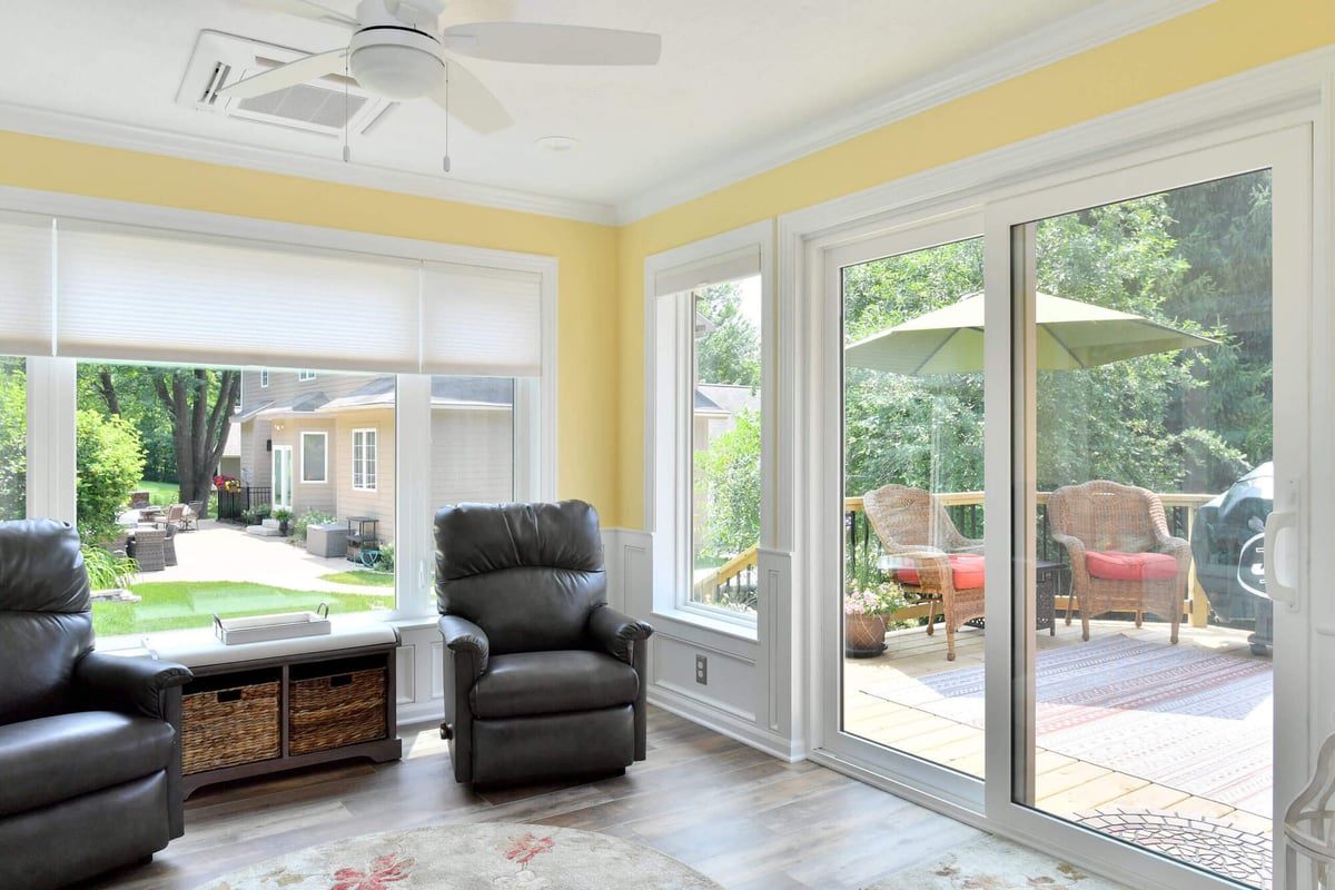 modern sunroom with patio door opening to deck addition by Odd Fellows Contracting in Okemos, MI