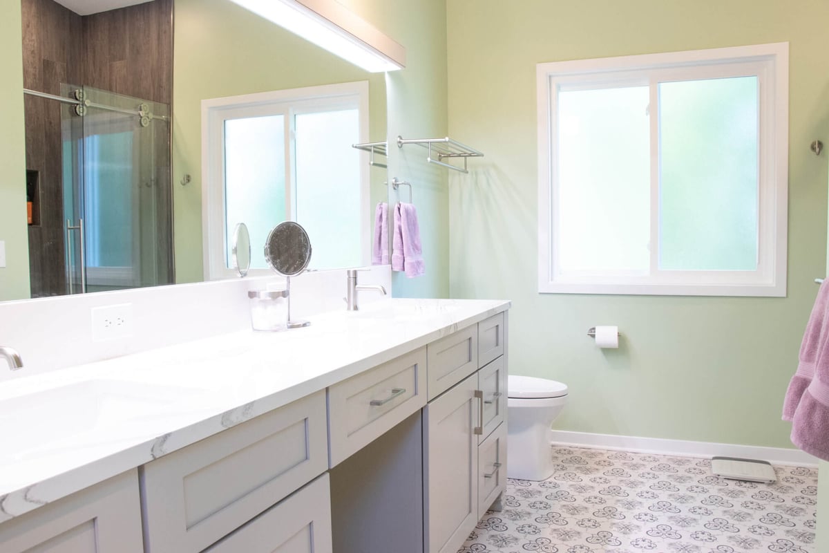 remodeled bathroom by Odd Fellows Contracting in Williamston MI with quartz vanity and tiled shower