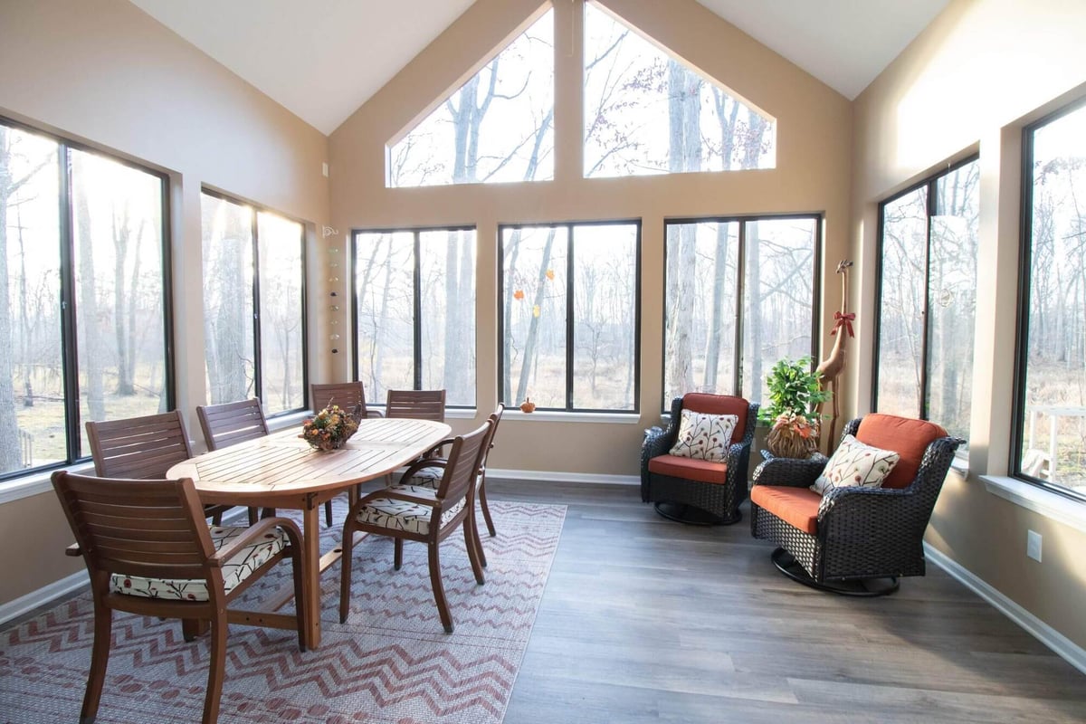 sunroom interior with vaulted ceiling and dining table by Odd Fellows Contracting in Haslett MI