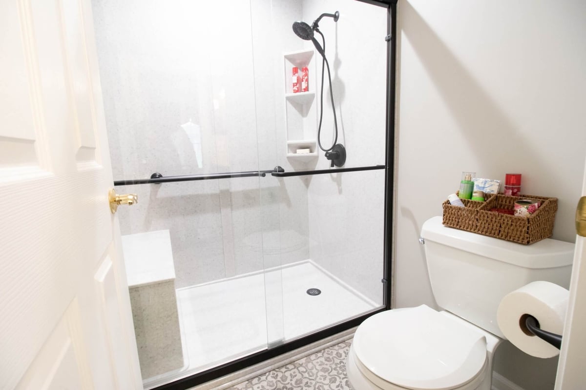 updated bathroom shower renovation with glass enclosure and tile surround by Odd Fellows Contracting in East Lansing MI