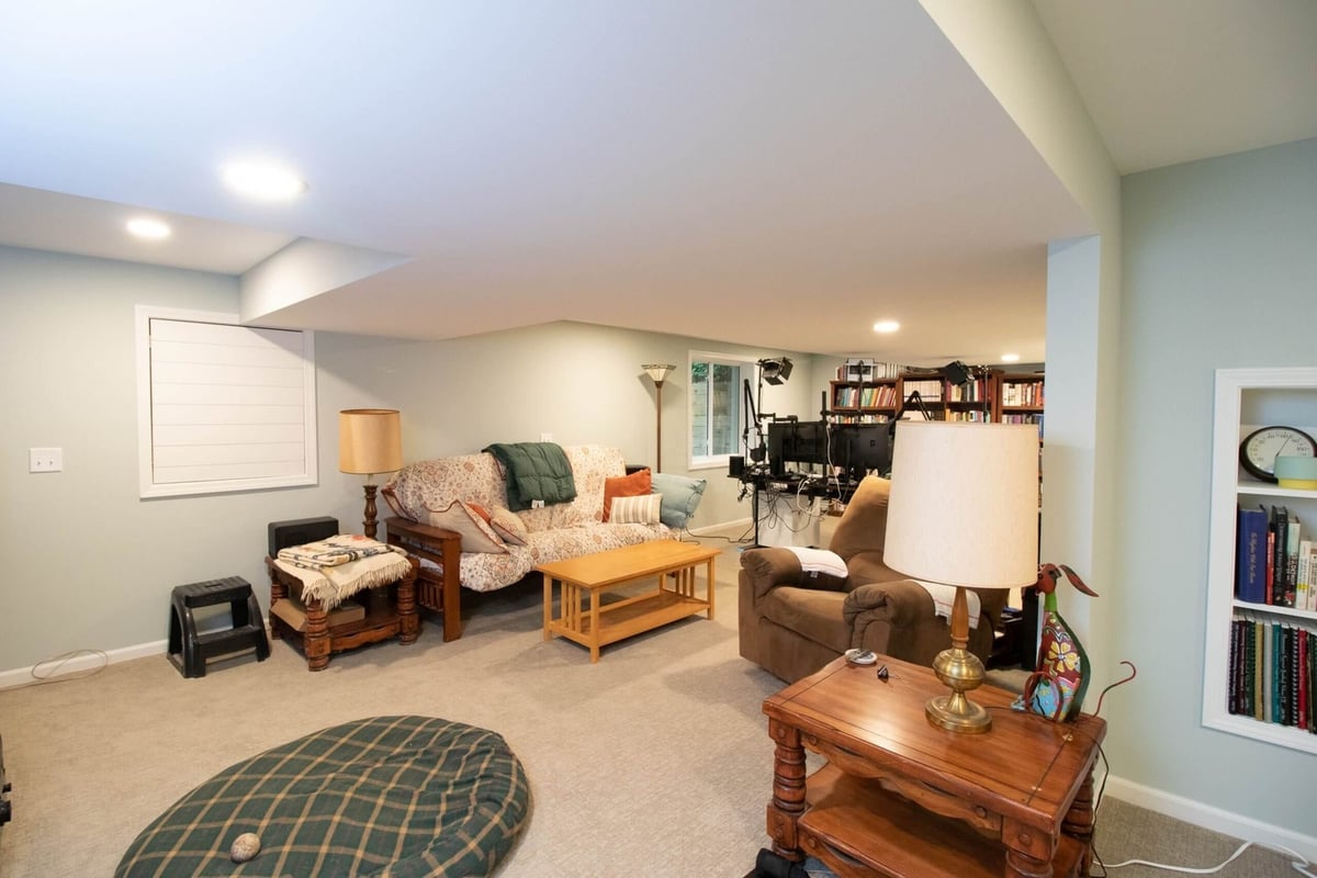 Basement remodel showing open living area and entertainment space by Odd Fellows Contracting in Lansing, MI.