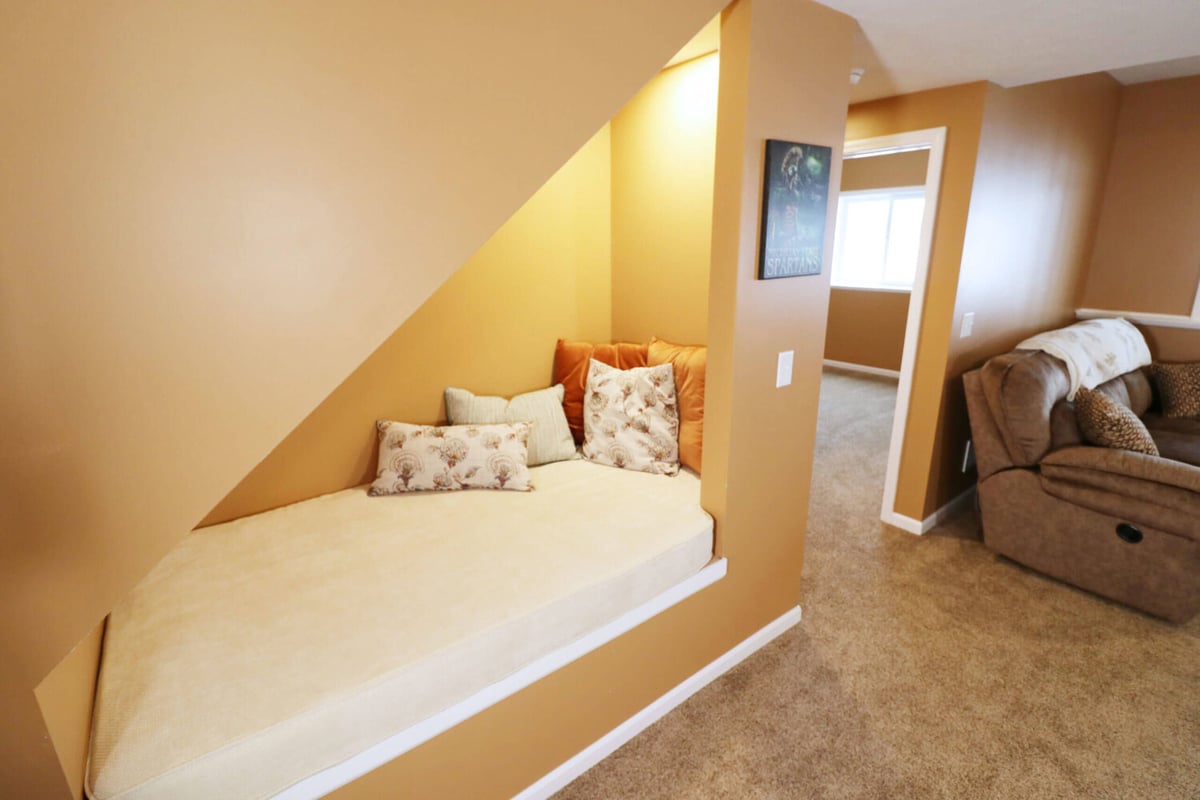 basement family room remodel with carpet flooring and painted walls by Odd Fellows Contracting Williamston MI