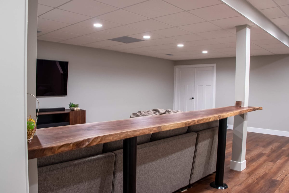 basement remodel by Odd Fellows Contracting in Mason MI with bar ledge overlooking seating area