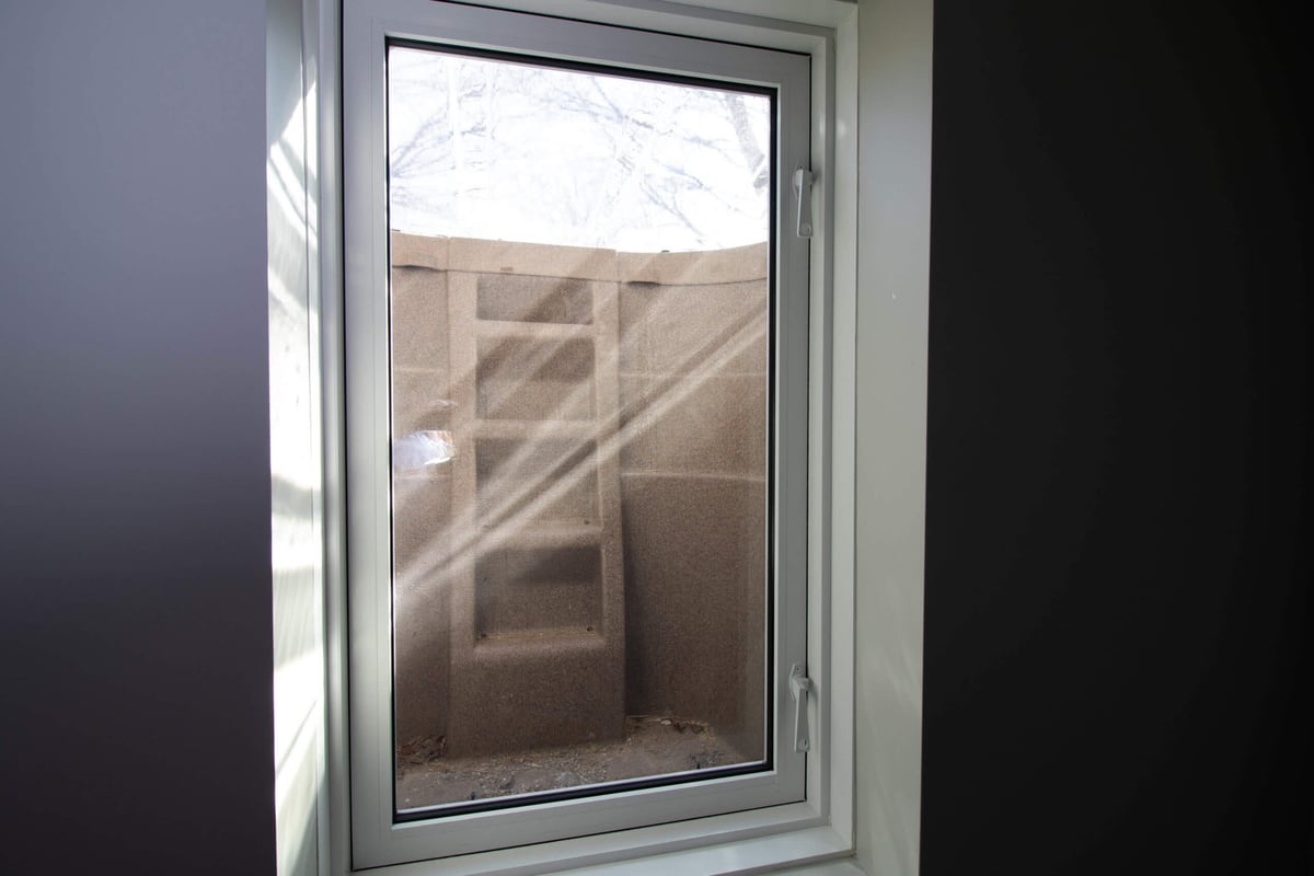 newly installed basement window by Odd Fellows Contracting in Mason MI improving ventilation and brightness