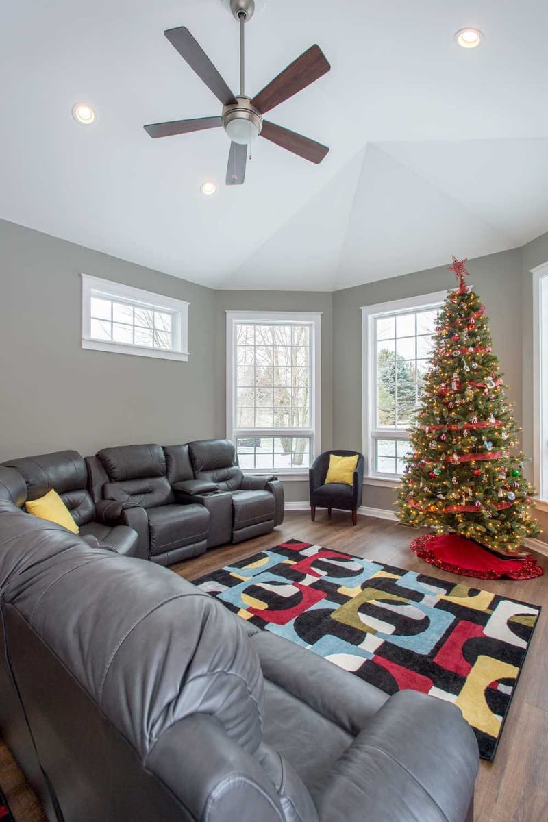 bright living room addition with vaulted ceiling and window wall by Odd Fellows Contracting in Okemos, MI