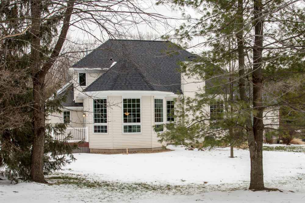 exterior family room addition with large windows and new roofline by Odd Fellows Contracting in Okemos, MI