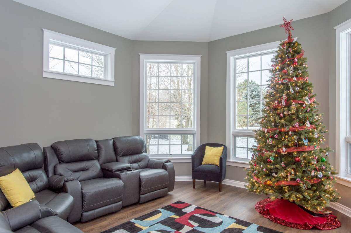family room addition with Christmas tree and large bay windows by Odd Fellows Contracting in Okemos, MI