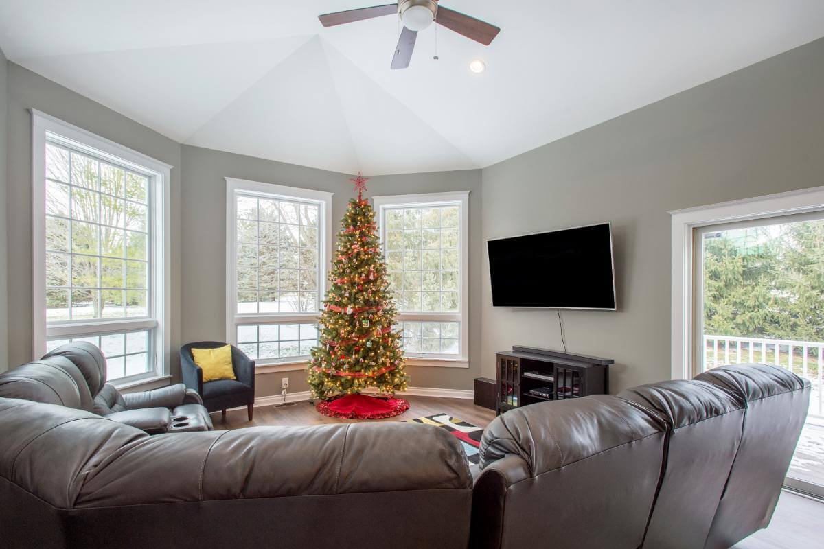 family room addition with vaulted ceiling and large bay windows by Odd Fellows Contracting in Okemos, MI
