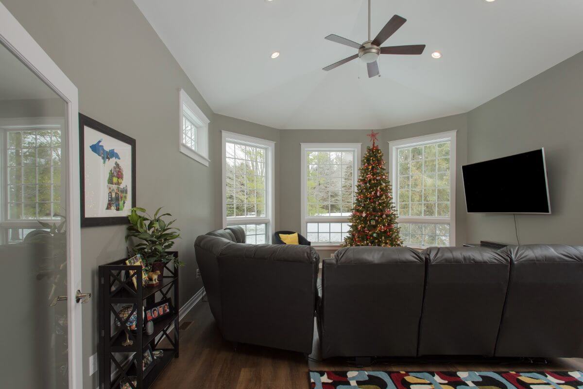 modern living room addition with recessed lighting and large windows by Odd Fellows Contracting in Okemos, MI