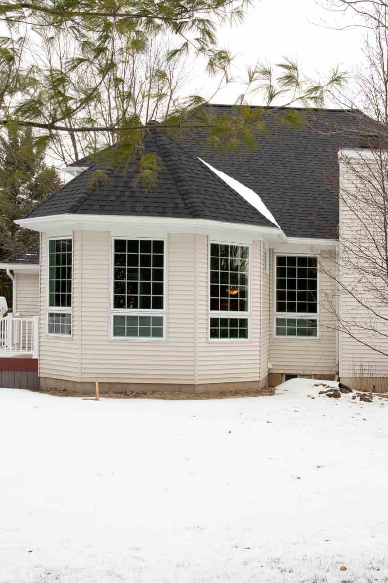 rear family room addition with porch and window wall by Odd Fellows Contracting in Okemos, MI