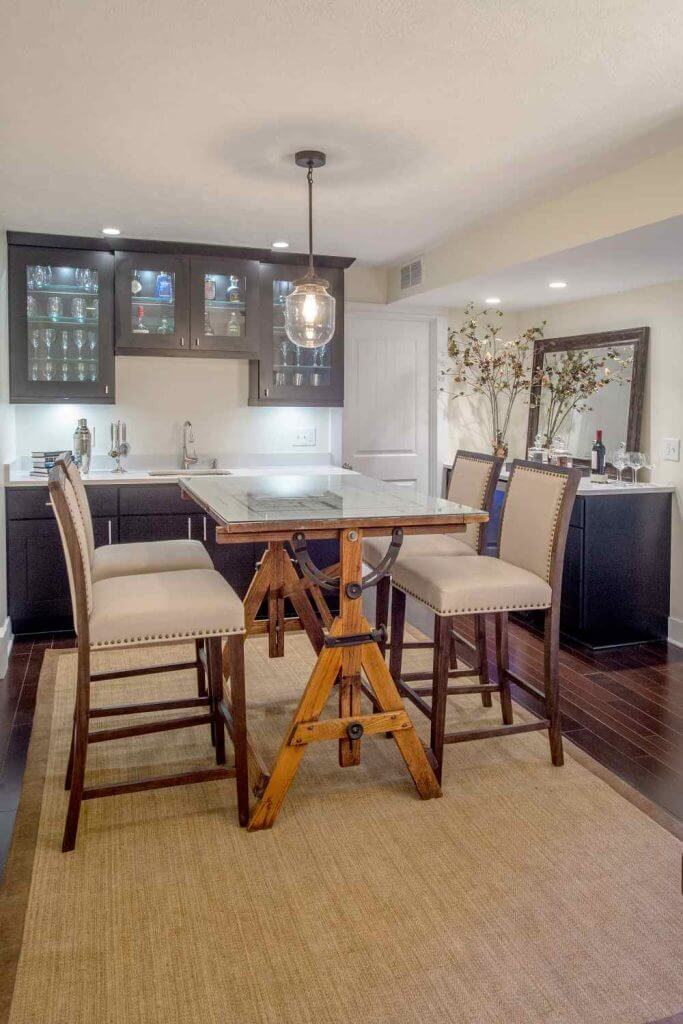 Basement bar and seating area with custom cabinetry built by Odd Fellows Contracting in Lansing MI