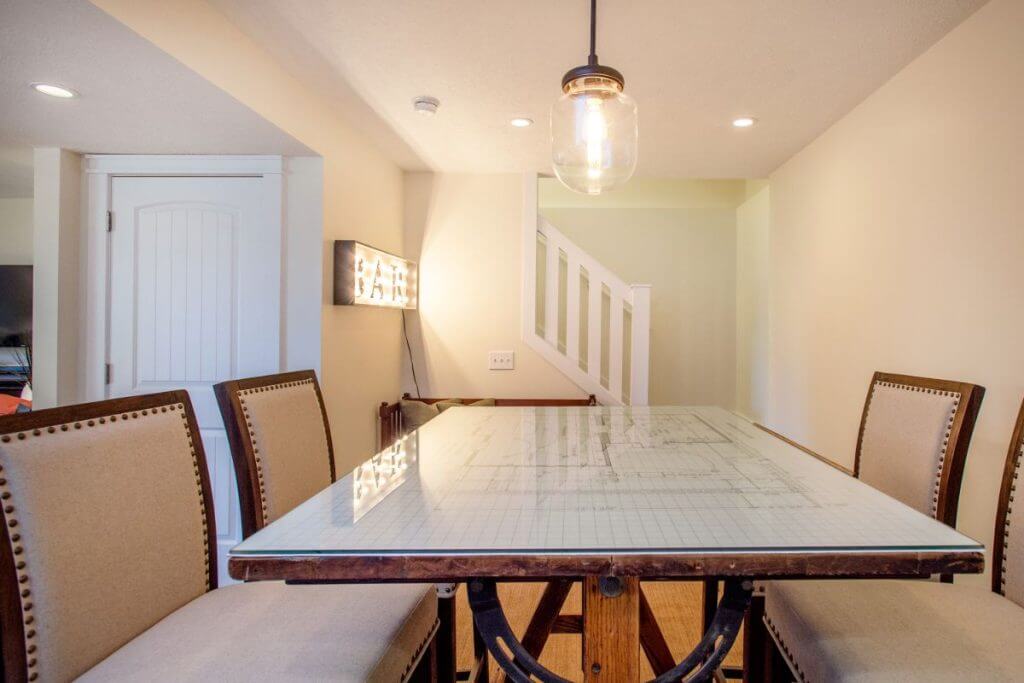 Basement entertainment area with seating and bar space by Lansing Michigan remodeling contractor