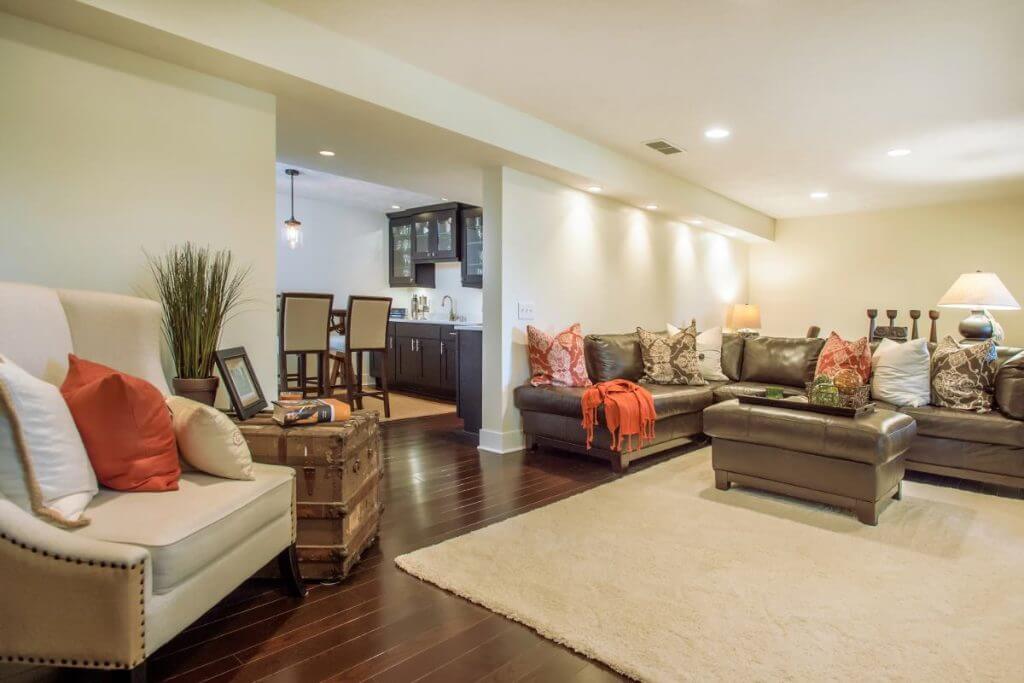 Finished basement living room with recessed lighting by Odd Fellows Contracting in Lansing Michigan