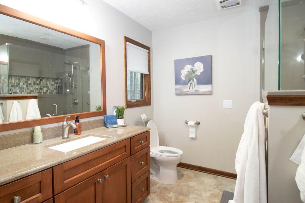 completed bathroom renovation featuring modern vanity and tile floor by Odd Fellows Contracting in Okemos, MI