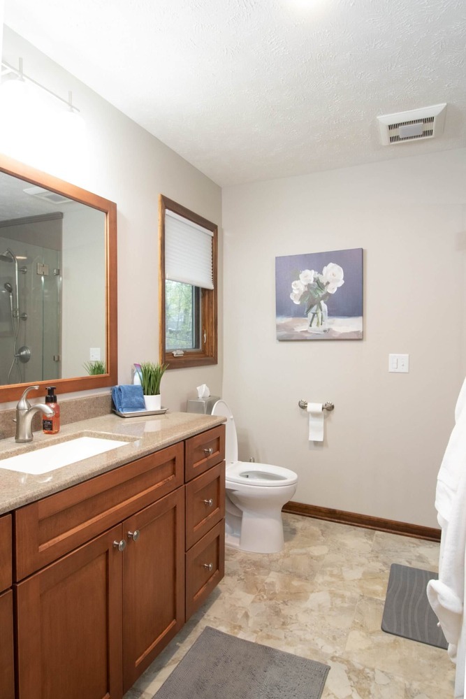 updated vanity station with custom cabinetry during bathroom remodel by Odd Fellows Contracting in Okemos, MI