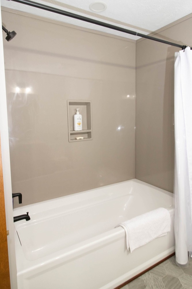newly installed bathtub and surround during bathroom remodel by Odd Fellows Contracting in Okemos, MI