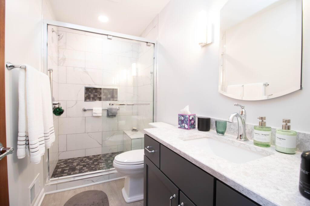 finished bathroom remodel with vanity and walk-in shower by Odd Fellows Contracting in East Lansing, MI