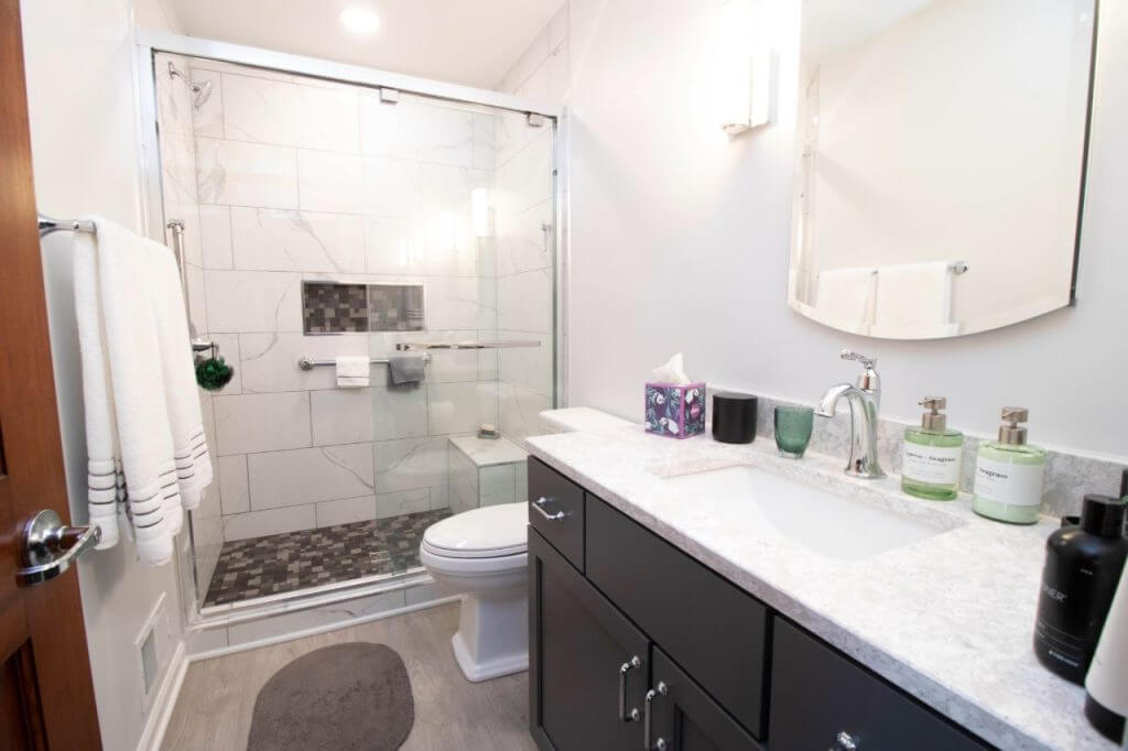 renovated bathroom interior with tiled shower and vanity by Odd Fellows Contracting in East Lansing, MI