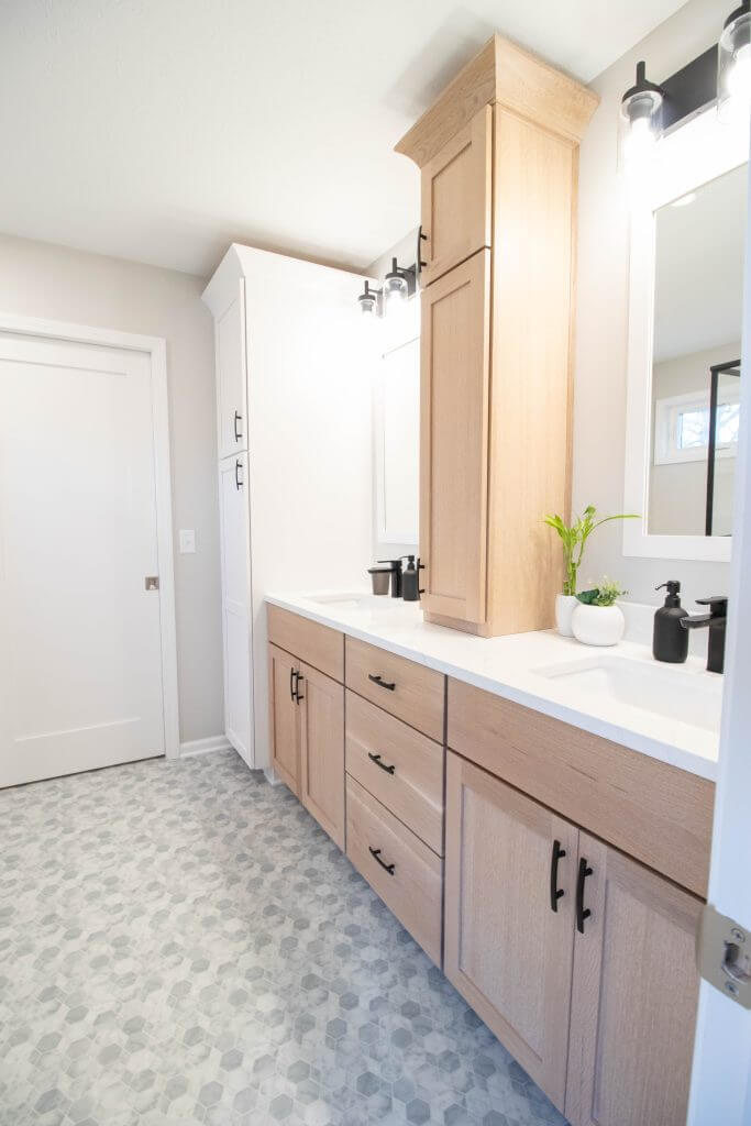 double vanity with natural wood cabinetry and quartz countertop from bathroom remodel by Odd Fellows Contracting in Okemos, MI