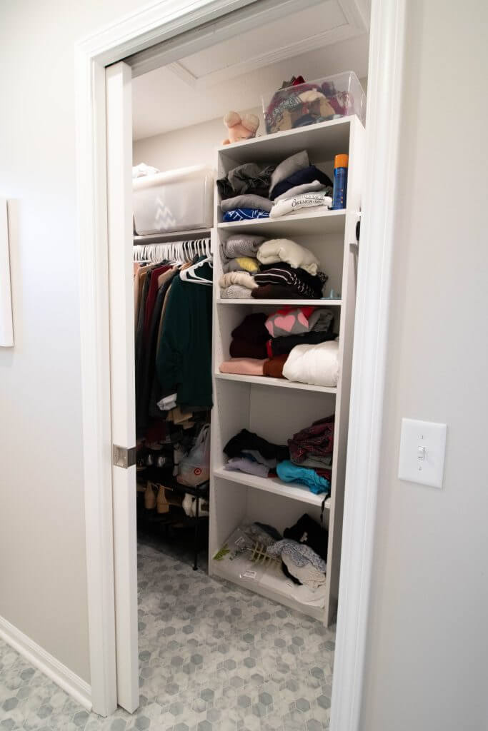 organized closet with shelving and hanging space added during bathroom remodel by Odd Fellows Contracting in Okemos, MI