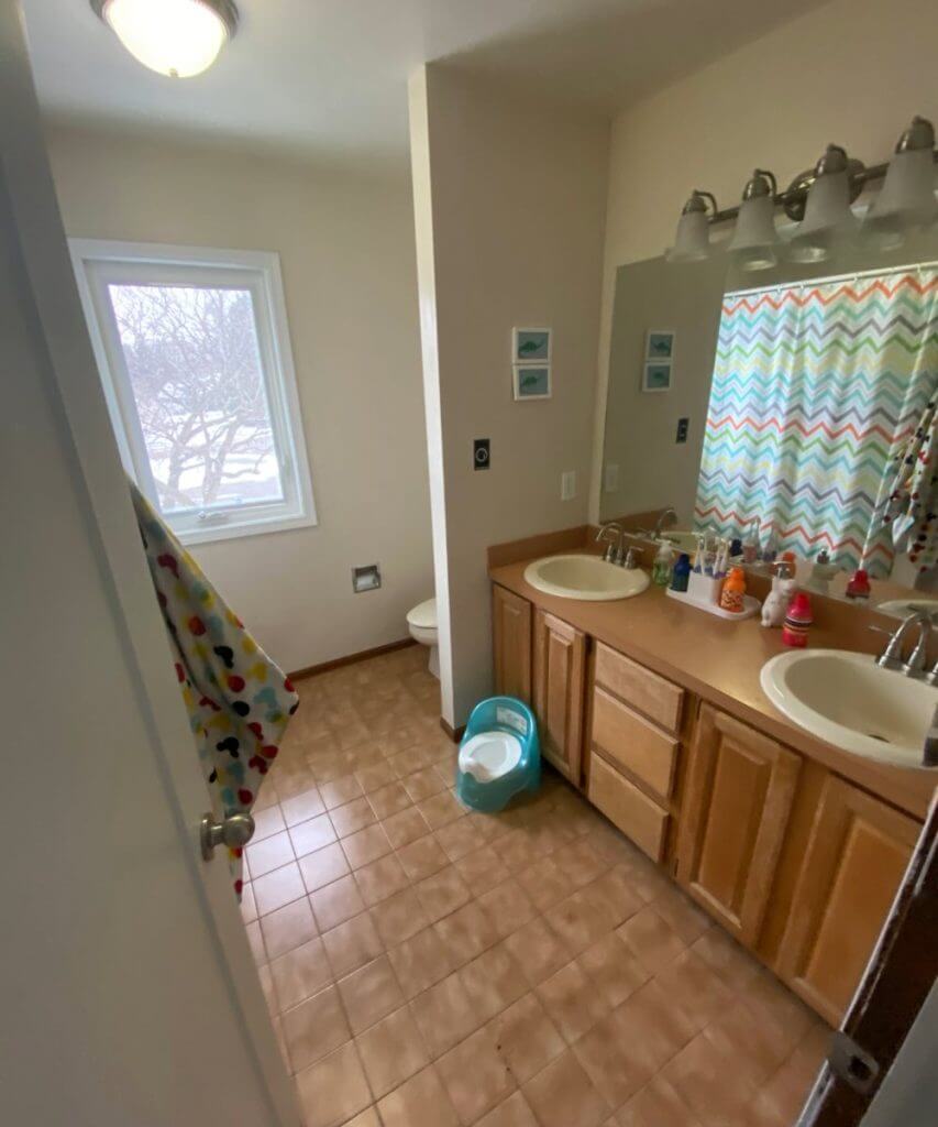 outdated bathroom with double vanity prior to remodel by Odd Fellows Contracting in Okemos, MI