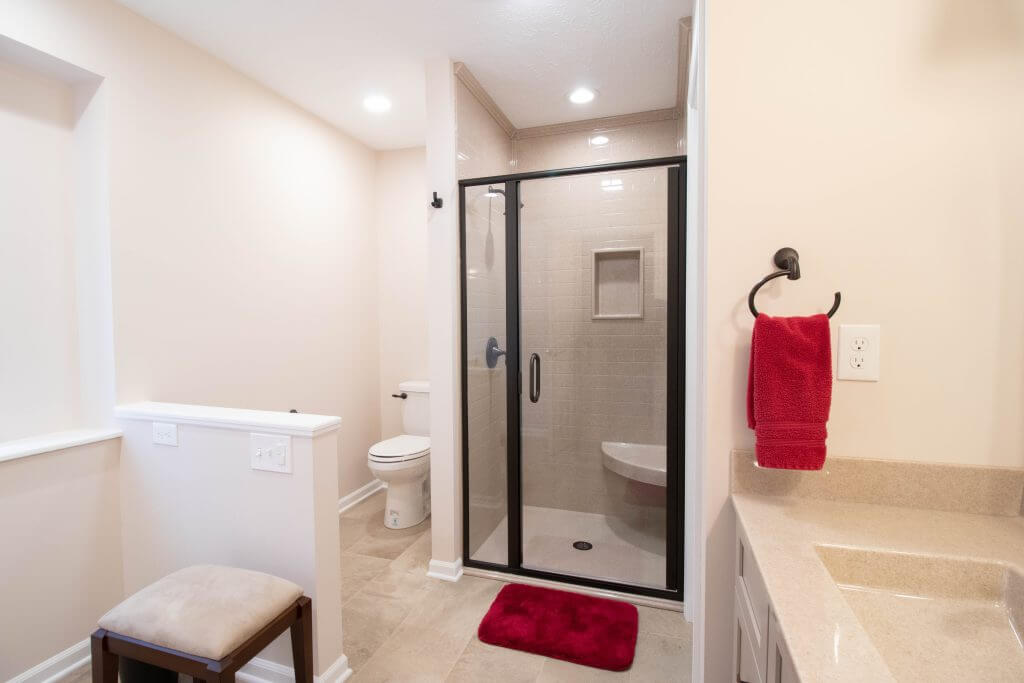 bathroom remodel featuring glass shower doors and updated fixtures by Odd Fellows Contracting in Lansing, MI