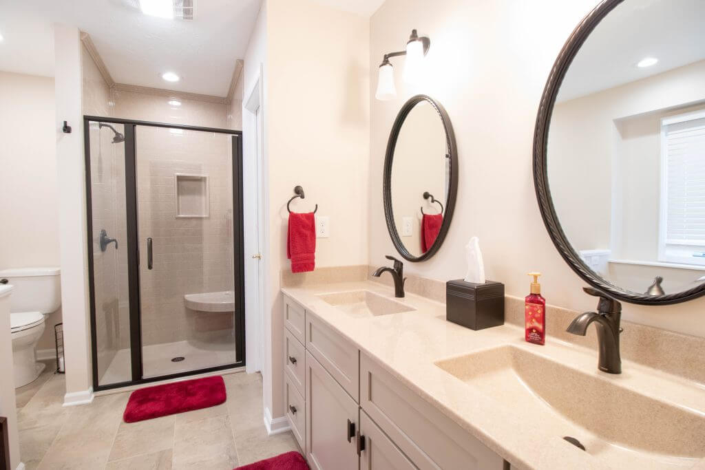 remodeled bathroom with double vanity and walk-in shower by Odd Fellows Contracting in Lansing, MI