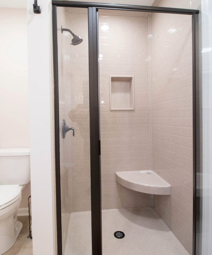 updated bathroom with walk-in shower and contemporary fixtures by Odd Fellows Contracting in Lansing, MI