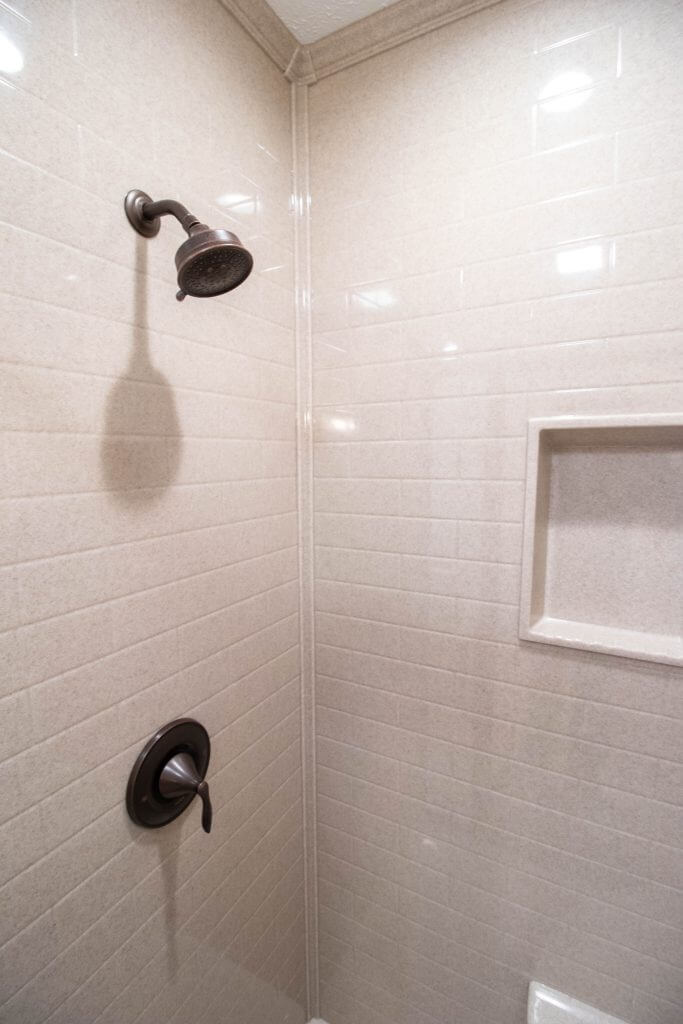 updated shower enclosure in bathroom remodel by Odd Fellows Contracting in Lansing, MI