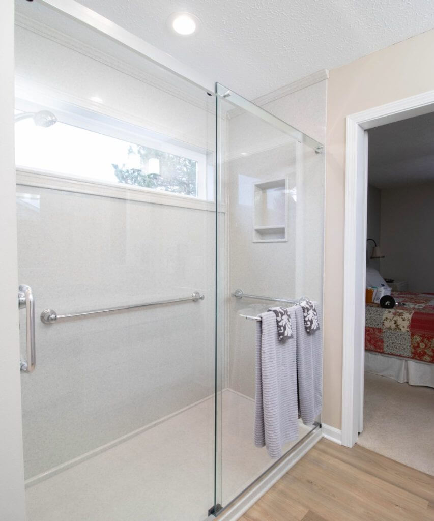 completed bathroom remodel with walk-in shower and laundry area by Odd Fellows Contracting in Dewitt, MI