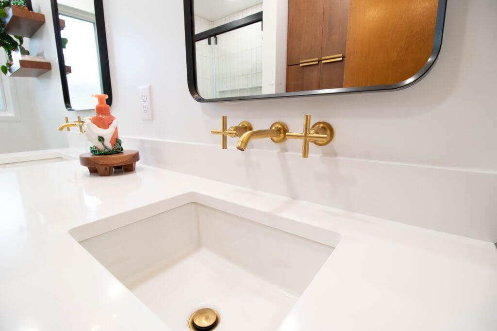 close-up of modern bathroom sink and faucet installed during remodel by Odd Fellows Contracting in Lansing, MI