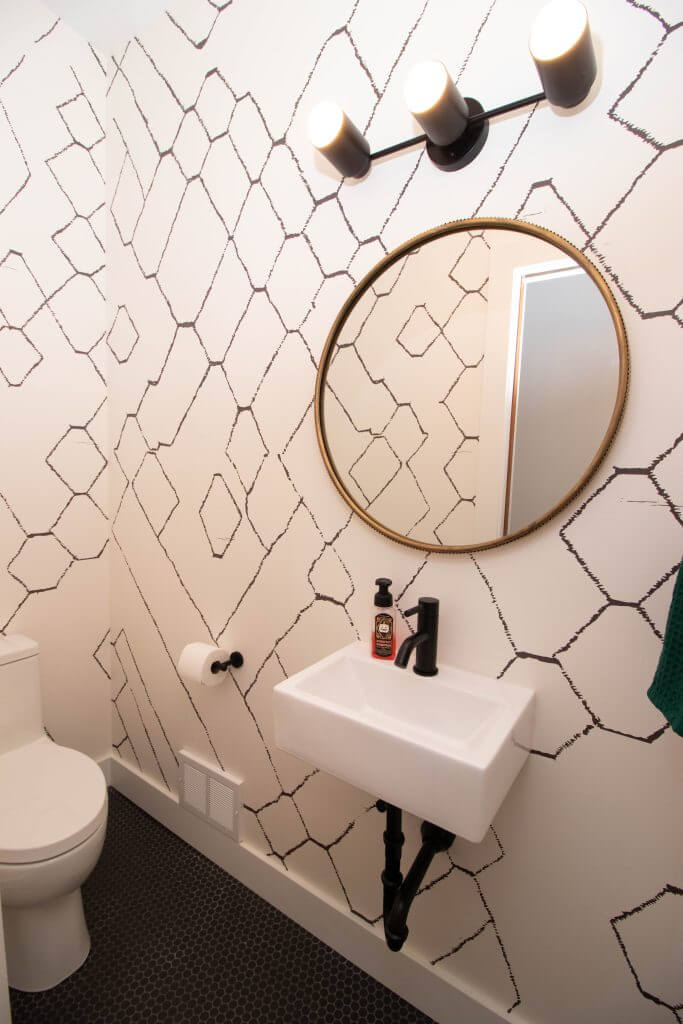 small bathroom renovation with pedestal sink and decorative wallpaper by Odd Fellows Contracting in Lansing, MI