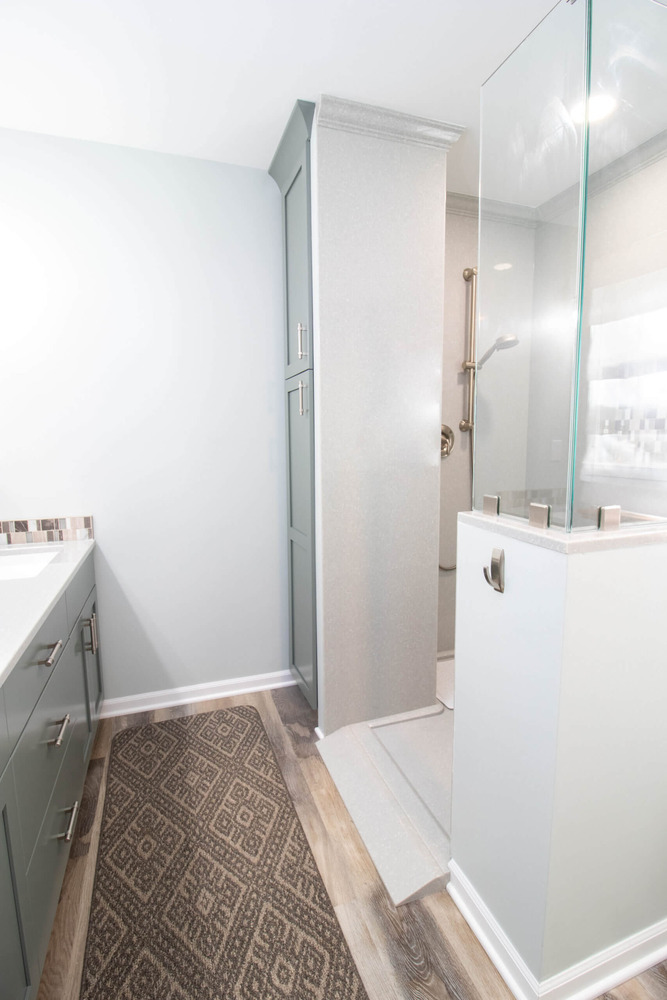updated bathroom with custom shower surround and storage cabinet by Odd Fellows Contracting in Laingsburg, MI