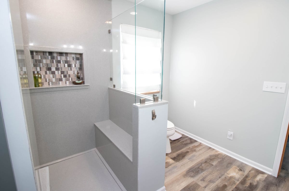 walk-in shower with glass panel and tile niche by Odd Fellows Contracting in Laingsburg, MI