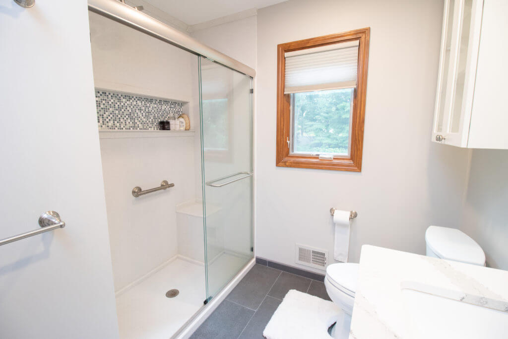 Walk-in shower with glass enclosure from bathroom remodel by Odd Fellows Contracting in Okemos, MI