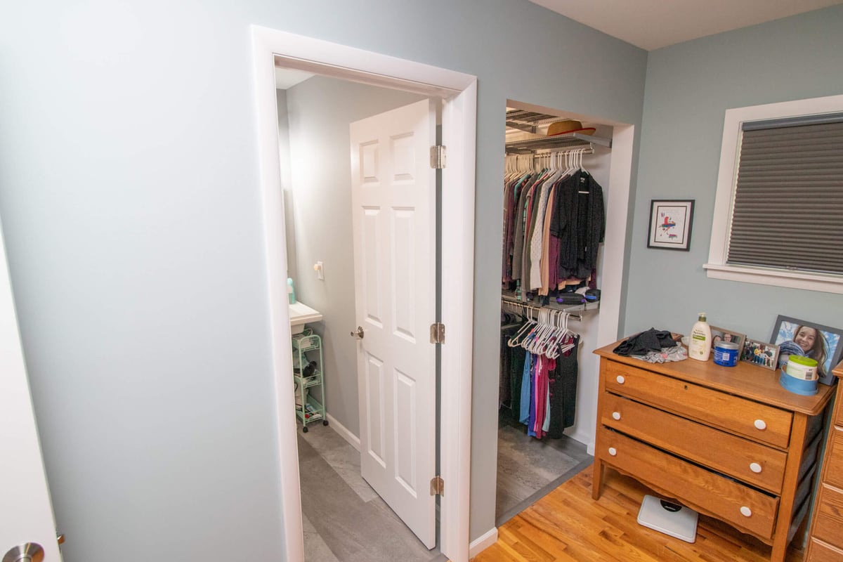 Bathroom addition and walk-in closet conversion completed by Odd Fellows Contracting in Haslett, MI with shelving and storage)