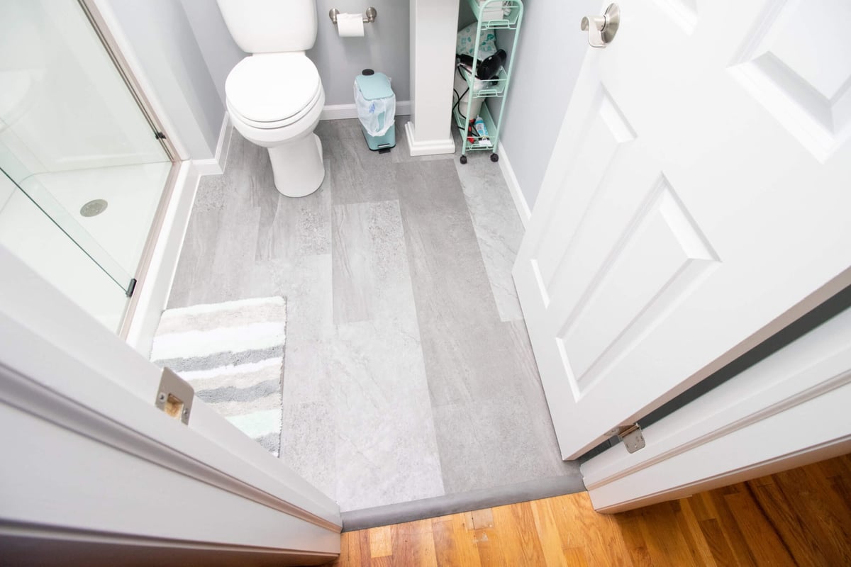 Luxury vinyl plank flooring installed in bathroom addition by Odd Fellows Contracting in Haslett, MI)