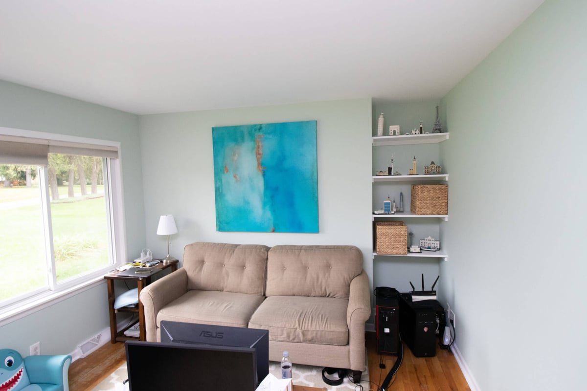 living room update completed alongside bathroom addition by Odd Fellows Contracting in Haslett, MI with new shelving and open layout