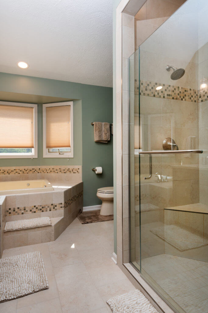 bathroom remodel with custom cabinet storage beside bathtub by Odd Fellows Contracting in Mason MI