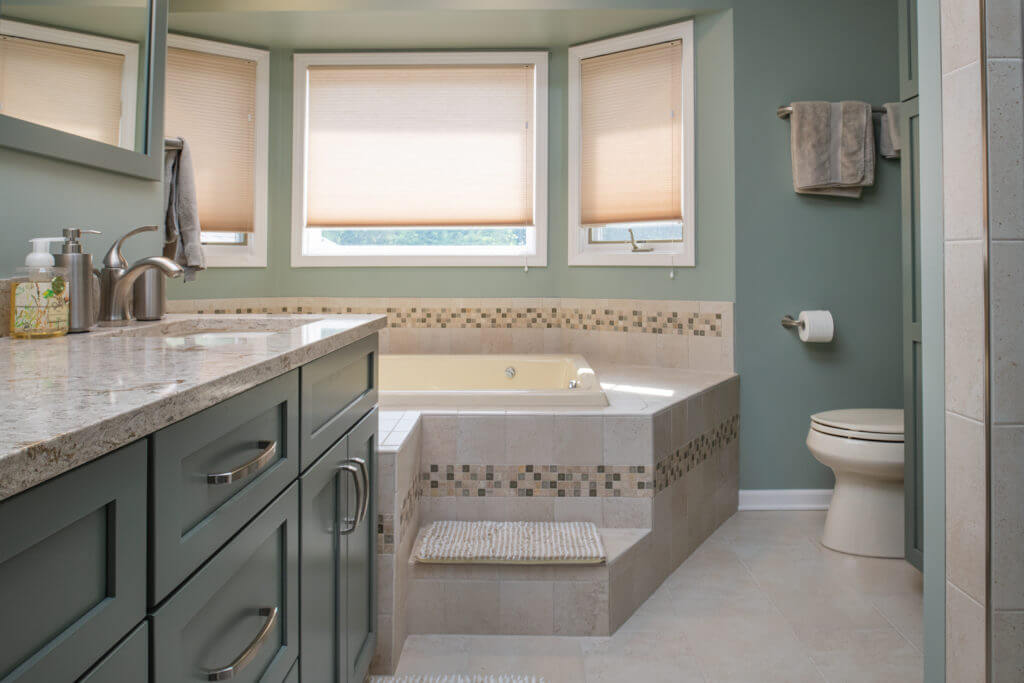 bathroom renovation with glass shower enclosure and tiled tub surround by Odd Fellows Contracting Mason MI