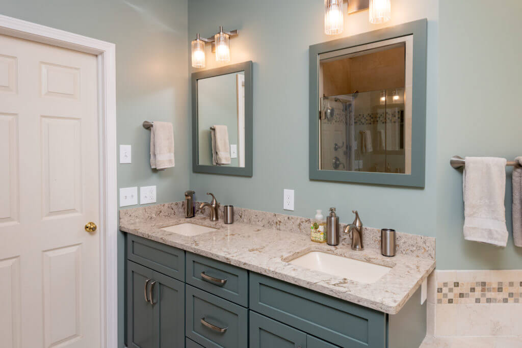double sink bathroom vanity with stone countertop in remodel by Odd Fellows Contracting Mason MI