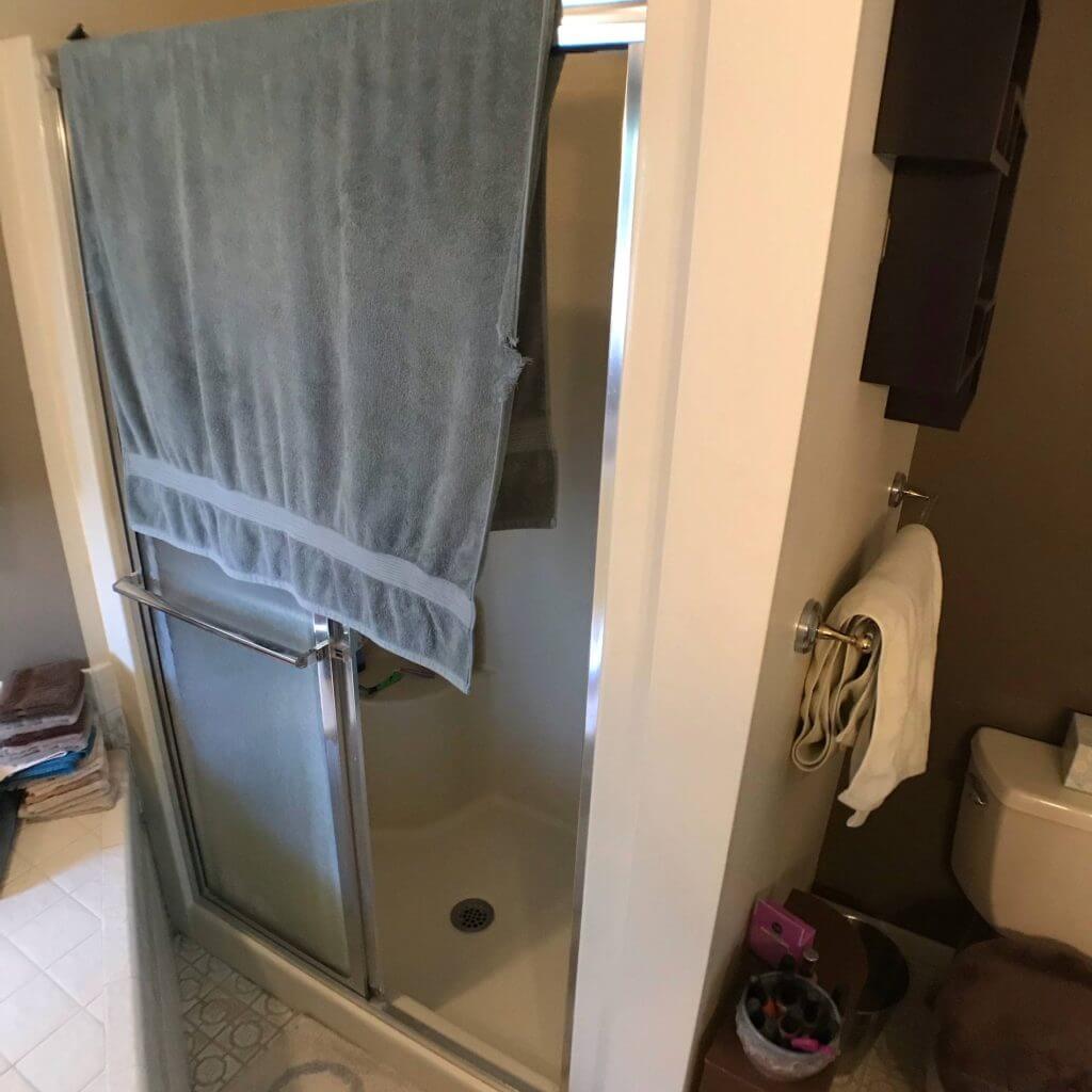 outdated bathroom shower and layout before remodel by Odd Fellows Contracting in Mason MI