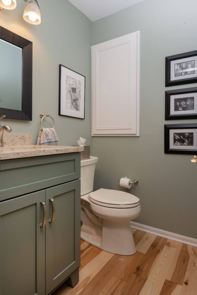 remodeled bathroom vanity with green cabinetry and quartz countertop by Odd Fellows Contracting Mason MI