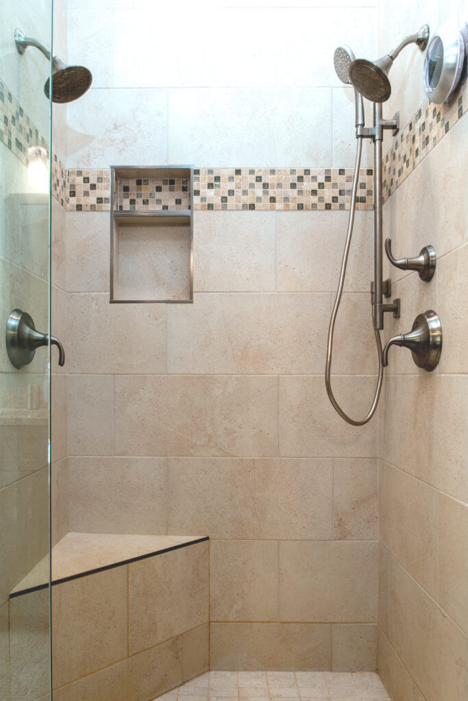 remodeled bathroom walk in shower with built in bench by Odd Fellows Contracting Mason MI