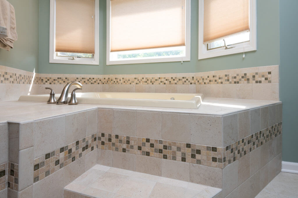 updated bathroom layout with tiled tub surround by Odd Fellows Contracting Mason MI