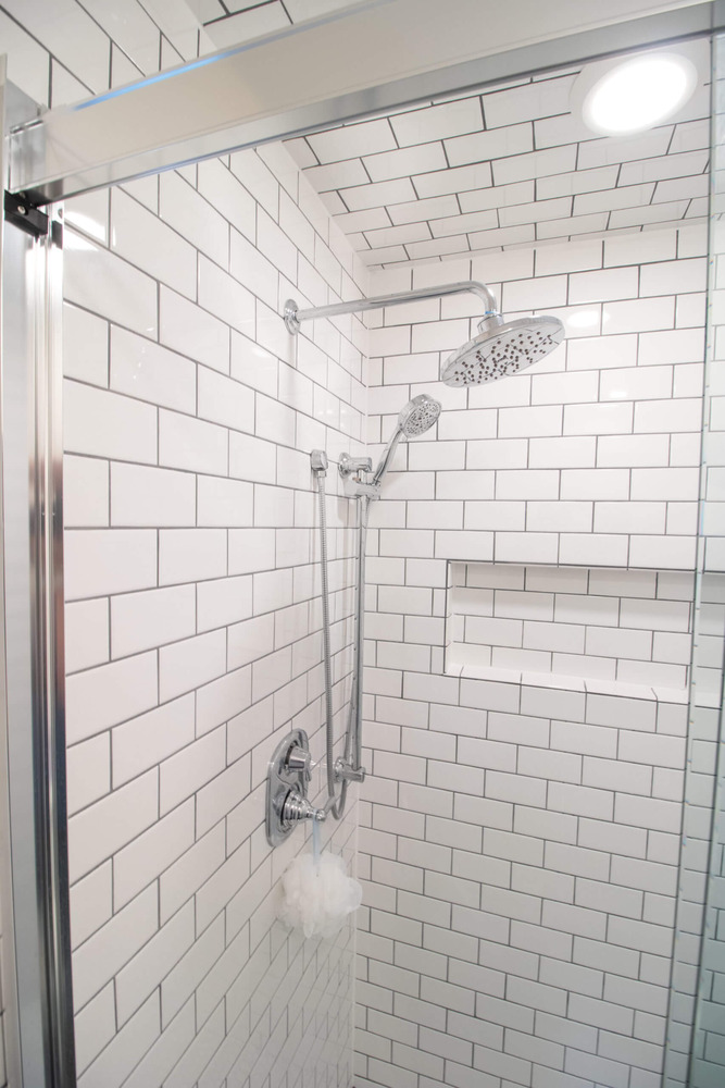 modern shower with built-in niche during bathroom renovation by Odd Fellows Contracting in Okemos MI