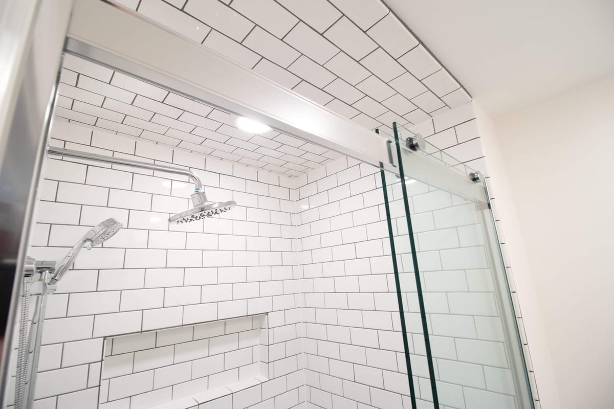 subway tile shower ceiling and glass enclosure by Odd Fellows Contracting in Okemos MI